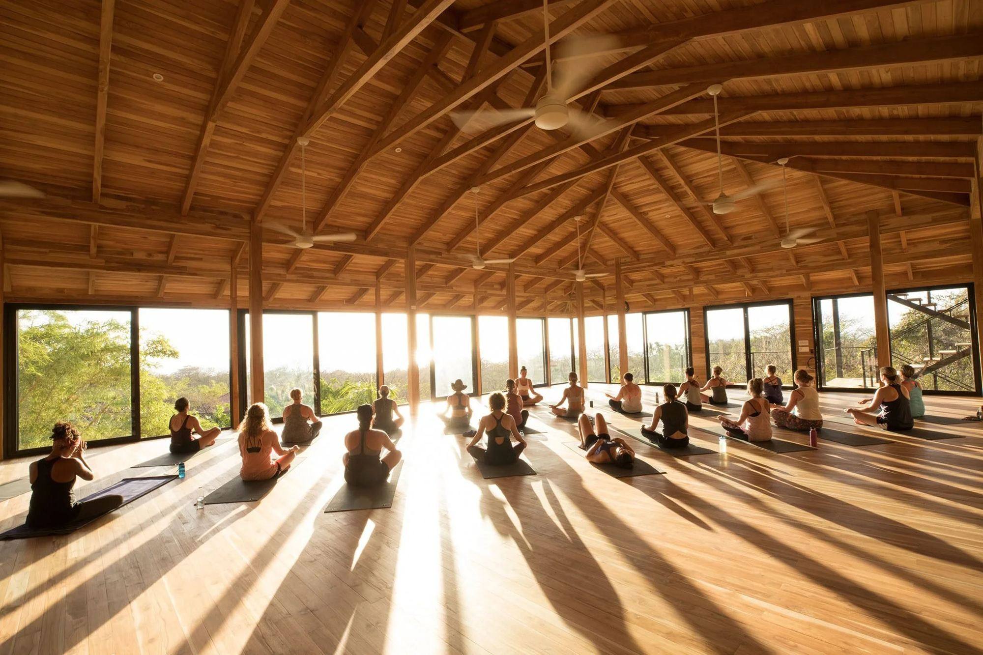 Open-air yoga shala at Bodhi Tree in Nosara at golden hour