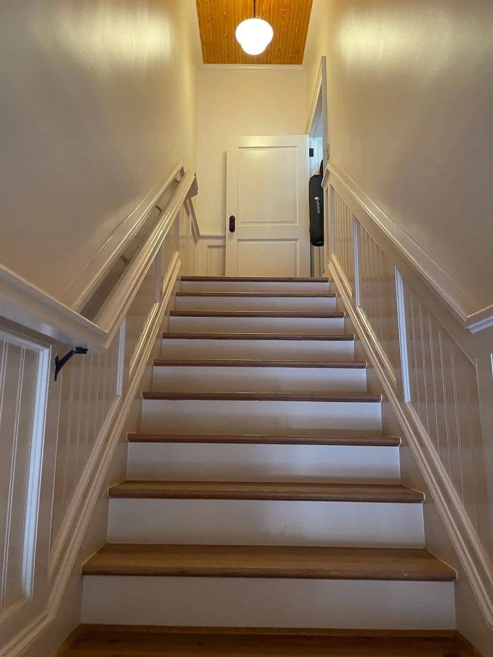 The white staircase leading up to the studio
